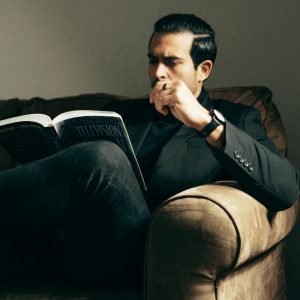 Elegant man with book on sofa