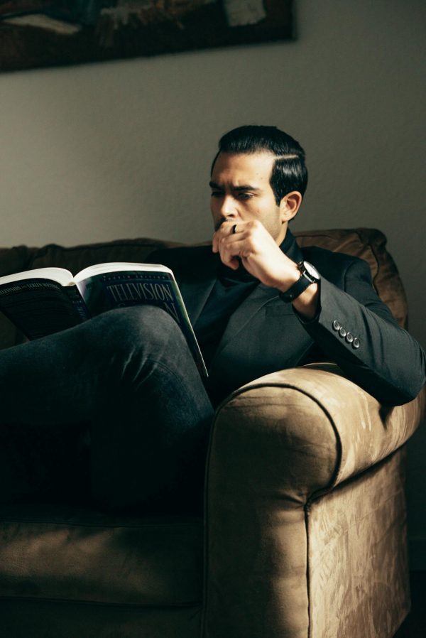 Elegant man with book on sofa