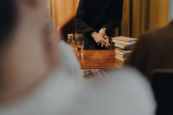 Man in Black Long Sleeve Shirt Sitting on Chair